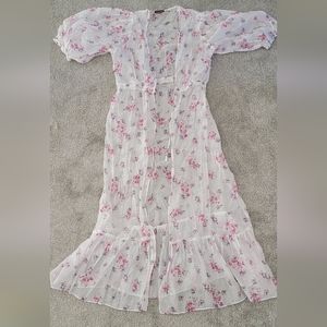 Sheer swimsuit cover up with floral pattern and puff sleeves.